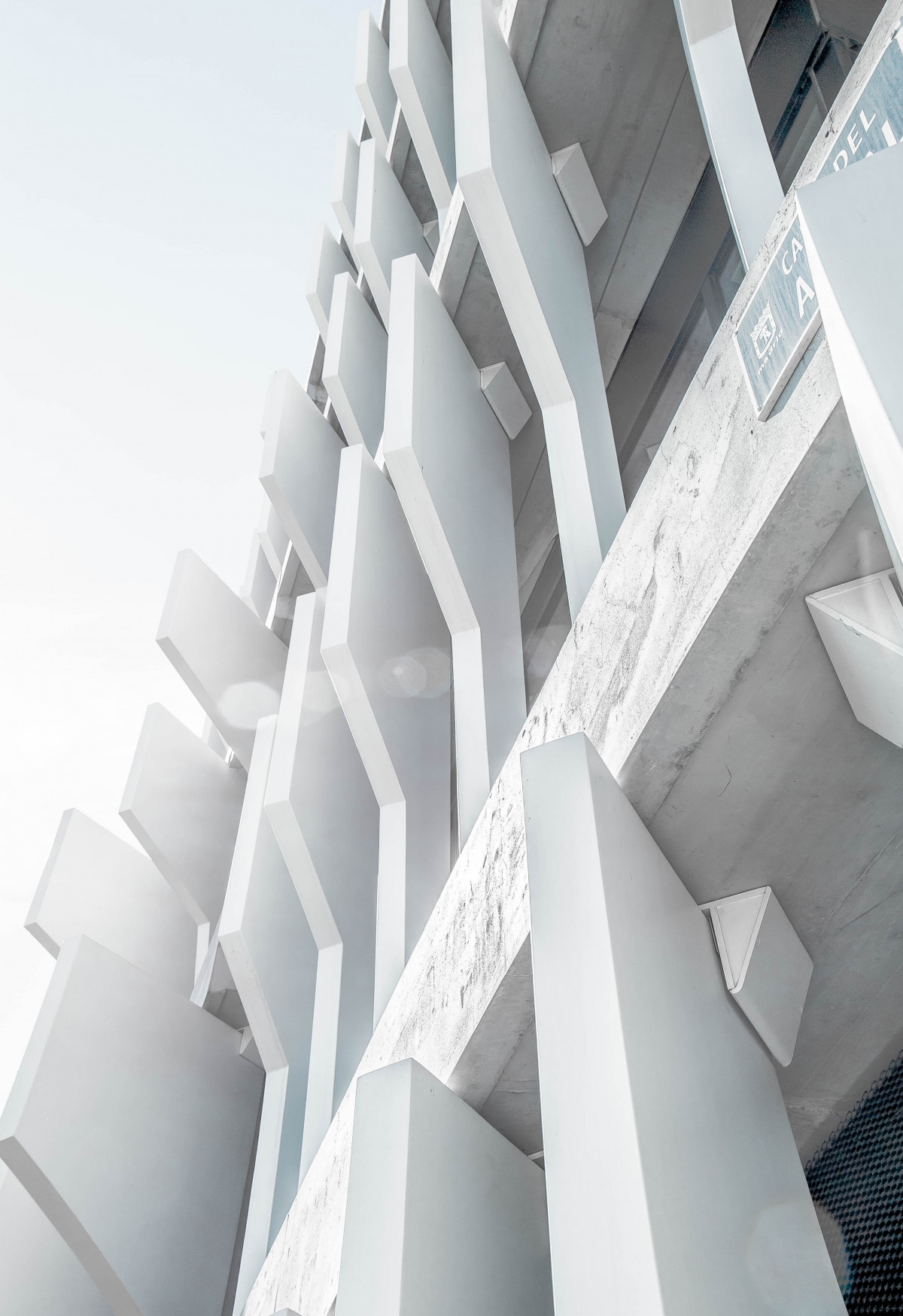 Sunlit white architectural facade with sculptural lines